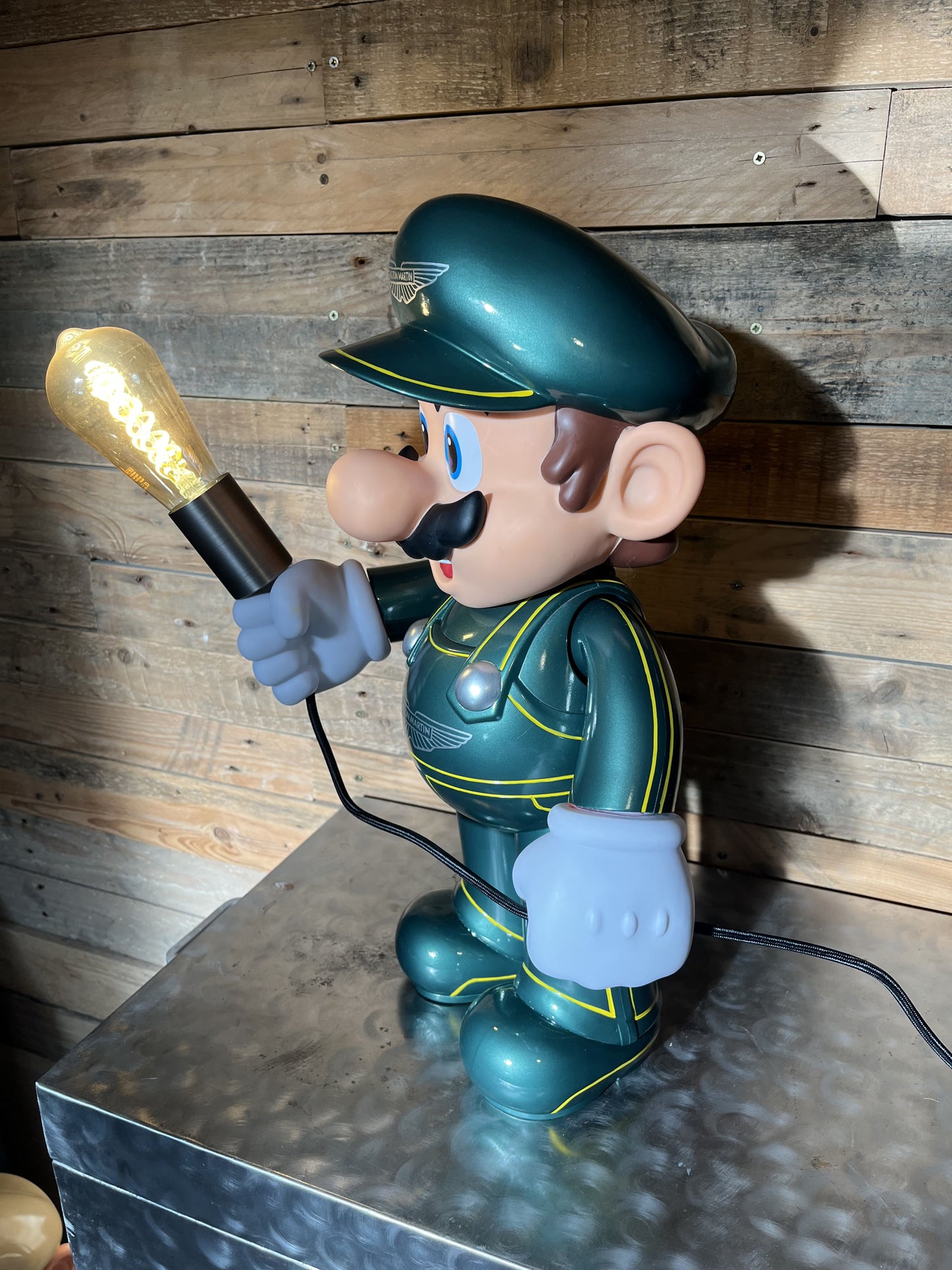Aston Martin green automotive vintage lamp made from a Super Mario miniature, created by Mathieu Ollevier from Vintage Addict, limited edition of 10, 50x30 cm format. Side view showcasing the handpainted detail, a collector’s piece for automotive, vintage and gaming enthusiasts.