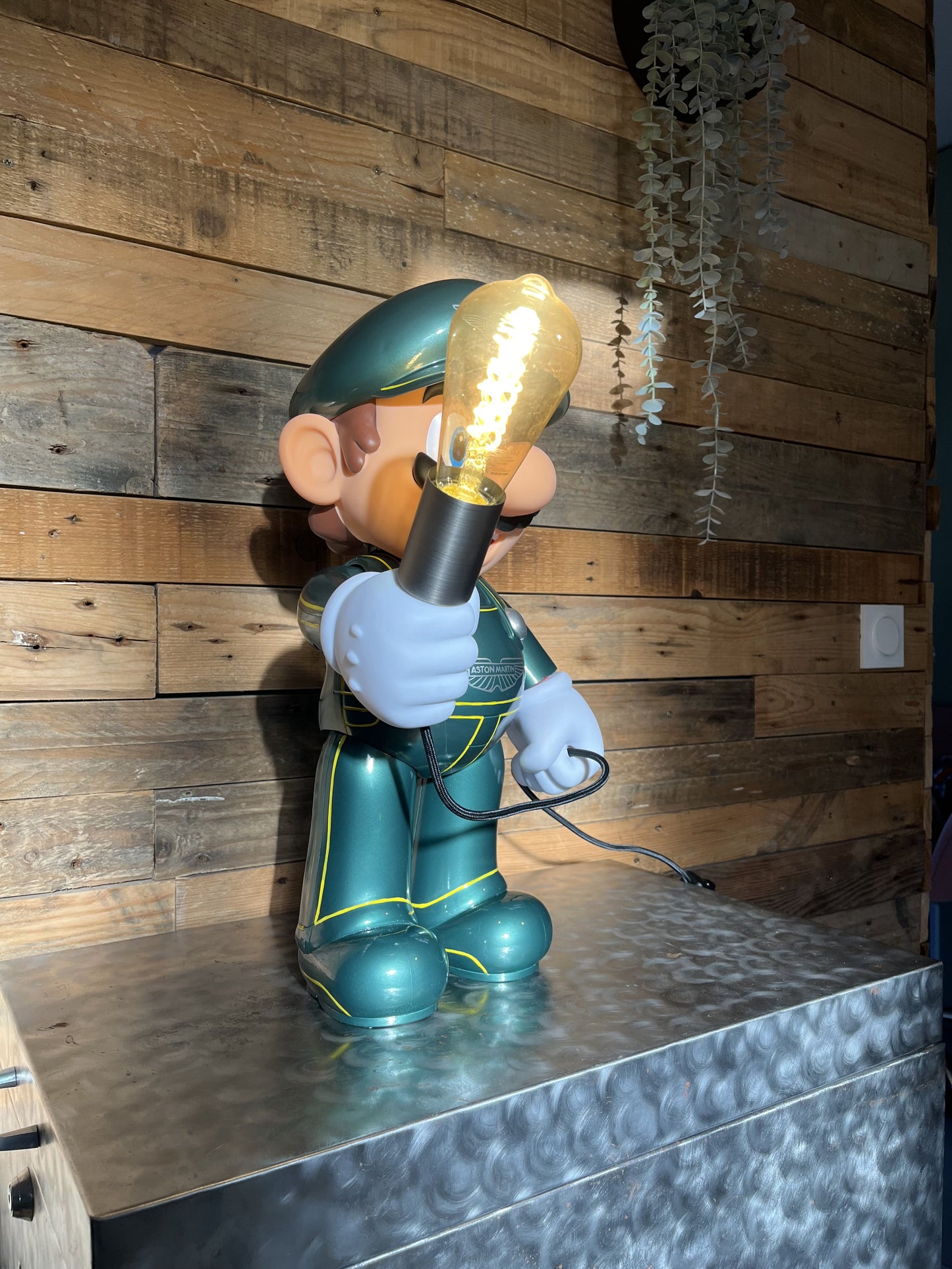 Aston Martin green automotive vintage lamp made from a Super Mario miniature, created by Mathieu Ollevier from Vintage Addict, limited edition of 10, 50x30 cm format. Lateral view showcasing the handpainted detail, a collector’s piece for automotive, vintage and gaming enthusiasts.