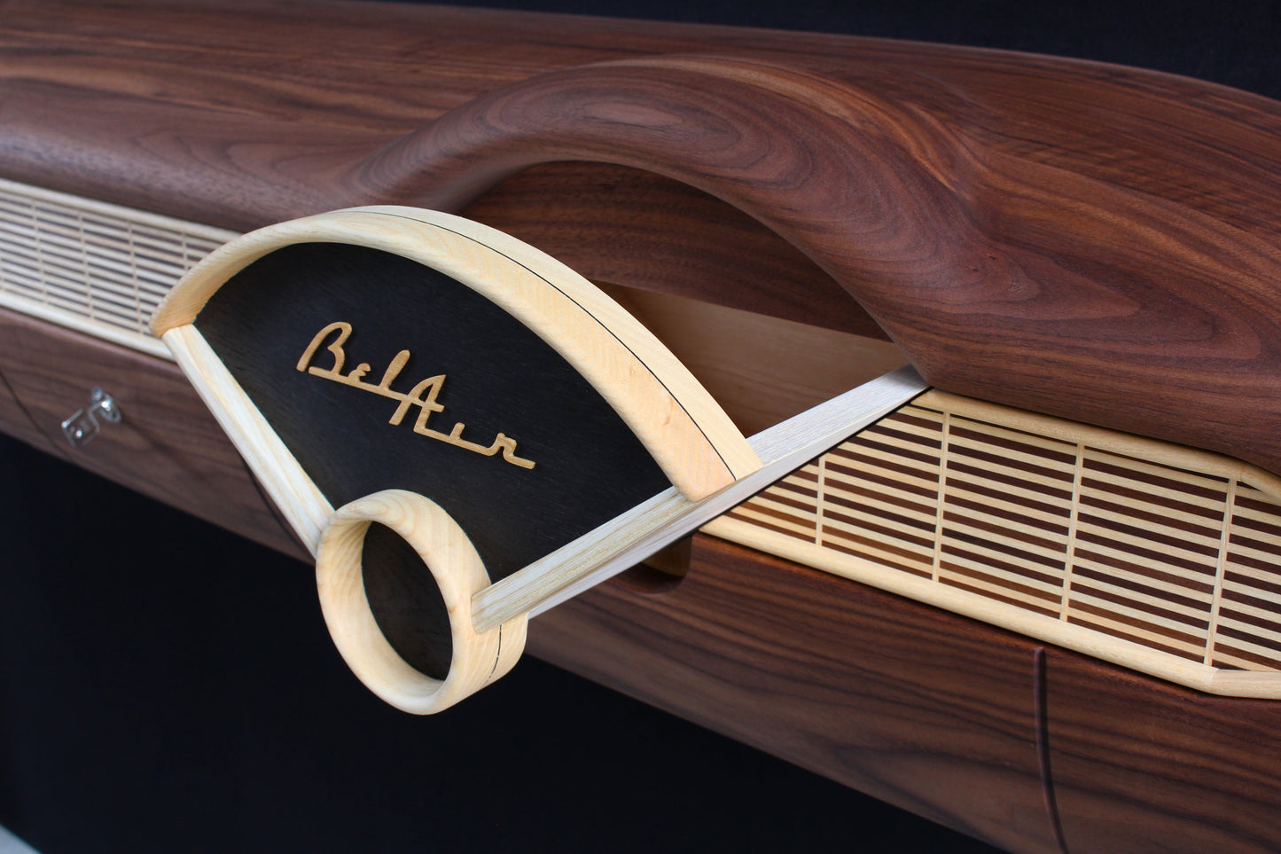 Solid wood furniture representing a Chevrolet Bel Air console, created by Stéphane Carton from Atelier Stéphane Carton, woodworker & cabinetmaker.
Limited edition of 25, 164 x 30 x 30 cm, handcrafted solid American walnut and ash structure, swamp oak veneer (fronts), oiled finish, hand application. Personalization possible.
Perfect for vintage automotive design lovers, classic cars enthusiasts and Chevrolet owners. Hidden drawer view.