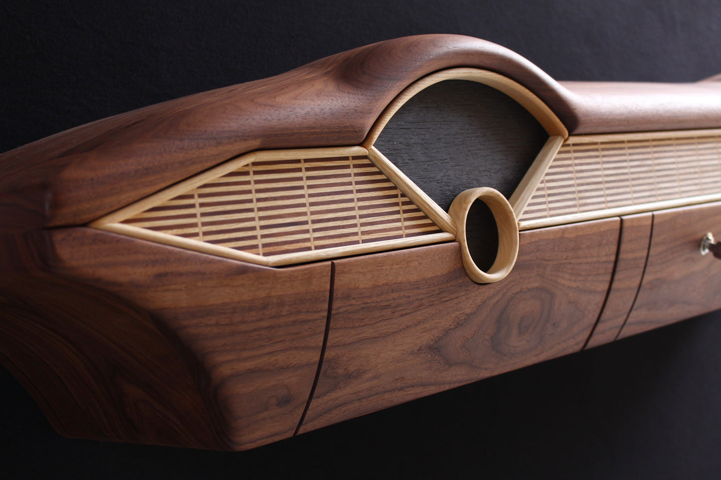 Solid wood furniture representing a Chevrolet Bel Air console, created by Stéphane Carton from Atelier Stéphane Carton, woodworker & cabinetmaker.
Limited edition of 25, 164 x 30 x 30 cm, handcrafted solid American walnut and ash structure, swamp oak veneer (fronts), oiled finish, hand application. Personalization possible.
Perfect for vintage automotive design lovers, classic cars enthusiasts and Chevrolet owners. Left view.