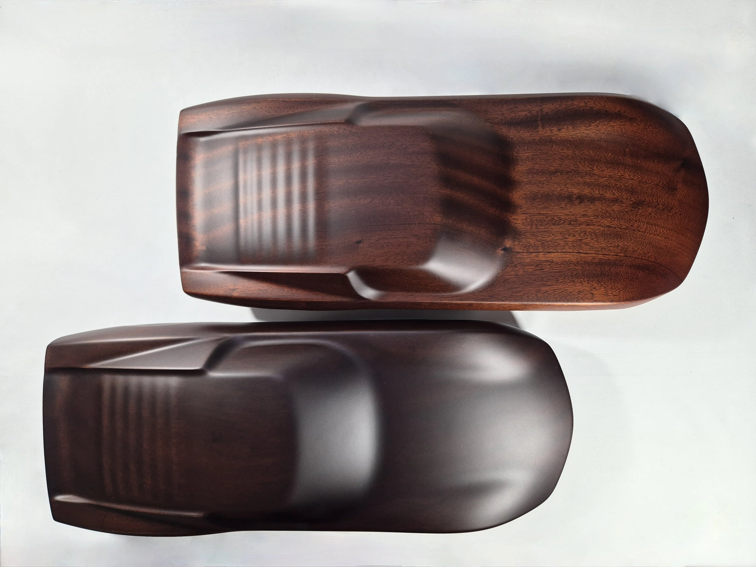 Two mahogany automotive sculptures side by side sculpted by french craftsman David Voisin (Maison V&P) showing different type of colors available for the Lamborghini Miura automotive sculpture (natural or ebony tint)