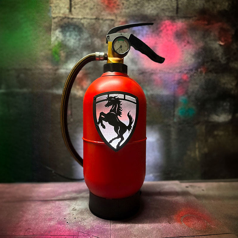 Fire extinguisher upcycled in a an automotive decoration lamp. Handpainted in red by Jean-Luc Rossier (JLR Concept) customized with the Ferrari logo. Front view with white light.