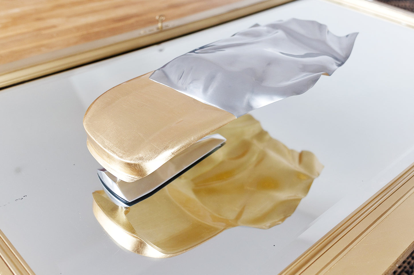 Metal sheet automotive sculpture with silver and gold finish representing GT draped, created by Frédéric Girard, limited edition of 8, 45 x 19 cm format. Top view showcasing the iconic curves and the meticulous attention to each sculpted detail, a collector’s piece for automotive and fine craftsmanship enthusiasts.