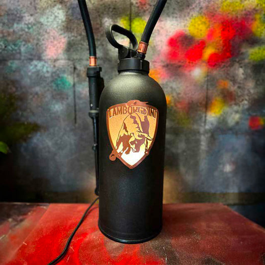 Fire extinguisher upcycled in an automotive decoration lamp. Handpainted in black by Jean-Luc Rossier (JLR Concept) customized with the Lamborghini logo. Front view with white light.