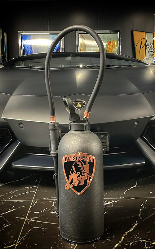 Fire extinguisher upcycled in an automotive decoration lamp. Handpainted in black by Jean-Luc Rossier (JLR Concept) customized with the Lamborghini logo. Side view with no light.