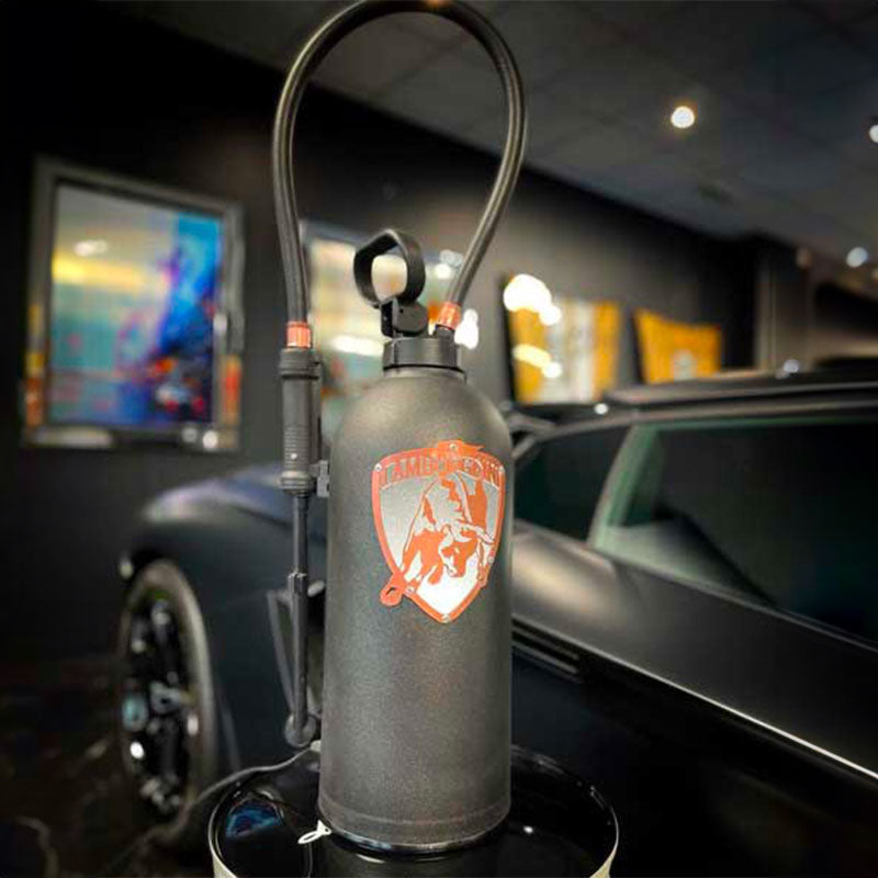 Fire extinguisher upcycled in an automotive decoration lamp. Handpainted in black by Jean-Luc Rossier (JLR Concept) customized with the Lamborghini logo. Side view with white light.