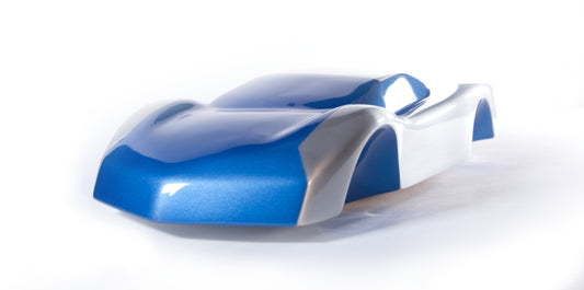 Metal sheet automotive sculpture with silver and gold finish representing V12 supercar, created by Frédéric Girard, limited edition of 8, 45 x 19 cm format. Front view showcasing the iconic curves and the meticulous attention to each sculpted detail, a collector’s piece for automotive and fine craftsmanship enthusiasts.