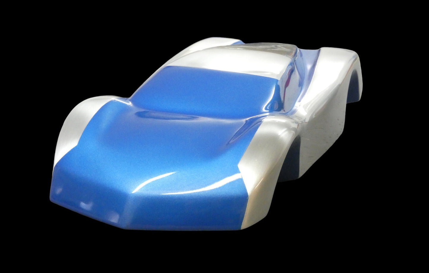 Metal sheet automotive sculpture with silver and gold finish representing V12 supercar, created by Frédéric Girard, limited edition of 8, 45 x 19 cm format. Front view showcasing the iconic curves and the meticulous attention to each sculpted detail, a collector’s piece for automotive and fine craftsmanship enthusiasts.