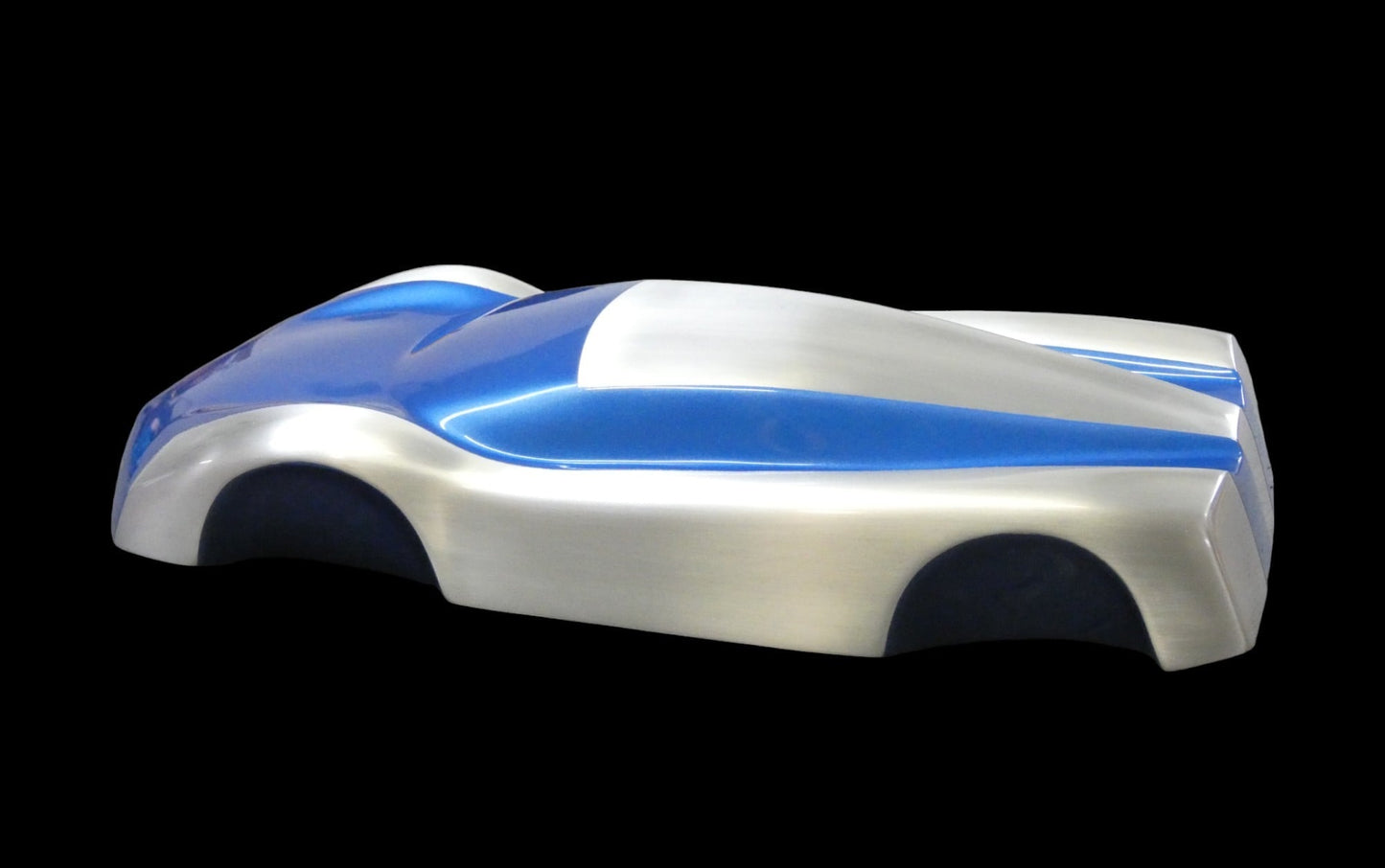 Metal sheet automotive sculpture with silver and gold finish representing V12 supercar, created by Frédéric Girard, limited edition of 8, 45 x 19 cm format. Side view showcasing the iconic curves and the meticulous attention to each sculpted detail, a collector’s piece for automotive and fine craftsmanship enthusiasts.