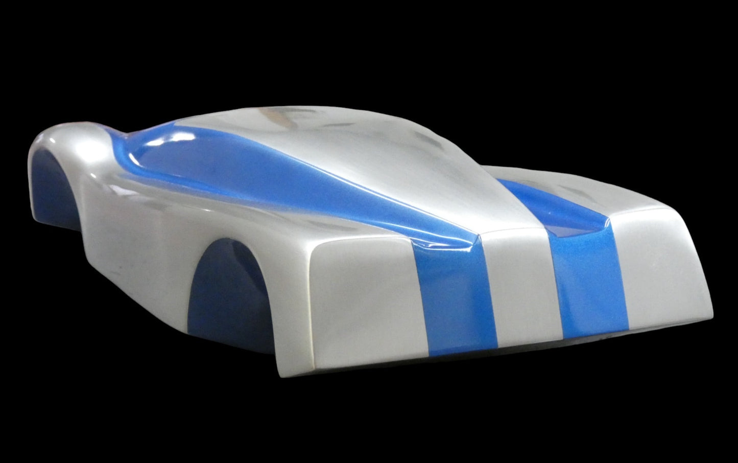 Metal sheet automotive sculpture with silver and gold finish representing V12 supercar, created by Frédéric Girard, limited edition of 8, 45 x 19 cm format. Tail view showcasing the iconic curves and the meticulous attention to each sculpted detail, a collector’s piece for automotive and fine craftsmanship enthusiasts.