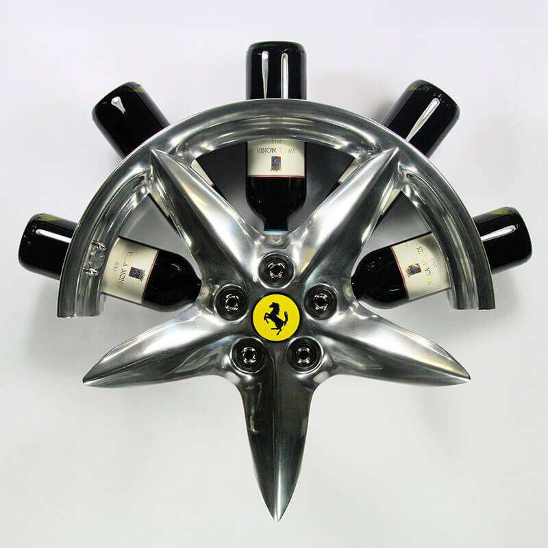 Front view of the car wheel rim bottle display stand made from a Ferrari 360 Modena wheel rim. This automotive art object measures 55x24 cm. Custom-made and handcrafted by Car2Art. Ideal for automotive art collectors. It can hold five bottles of wine or spirits