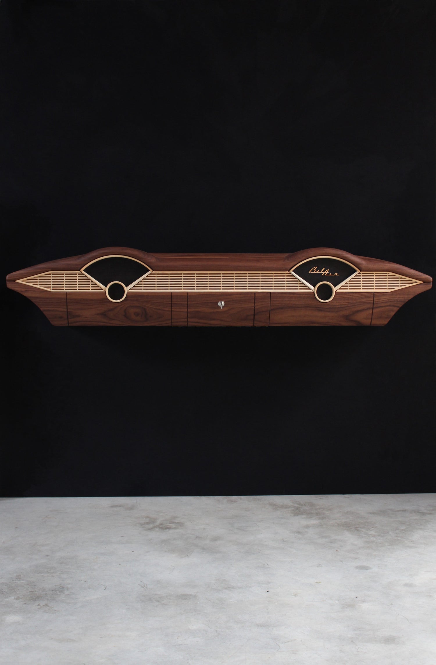 Solid wood furniture representing a Chevrolet Bel Air console, created by Stéphane Carton from Atelier Stéphane Carton, woodworker & cabinetmaker.

Limited edition of 25, 164 x 30 x 30 cm, handcrafted solid American walnut and ash structure, swamp oak veneer (fronts), oiled finish, hand application. Personalization possible.

Perfect for vintage automotive design lovers, classic cars enthusiasts and Chevrolet owners. Front full view.

