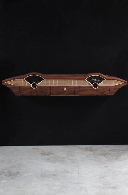 Solid wood furniture representing a Chevrolet Bel Air console, created by Stéphane Carton from Atelier Stéphane Carton, woodworker & cabinetmaker.

Limited edition of 25, 164 x 30 x 30 cm, handcrafted solid American walnut and ash structure, swamp oak veneer (fronts), oiled finish, hand application. Personalization possible.

Perfect for vintage automotive design lovers, classic cars enthusiasts and Chevrolet owners. Front full view.
