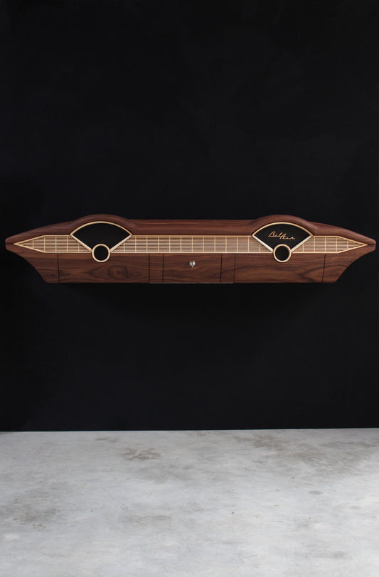 Solid wood furniture representing a Chevrolet Bel Air console, created by Stéphane Carton from Atelier Stéphane Carton, woodworker & cabinetmaker.

Limited edition of 25, 164 x 30 x 30 cm, handcrafted solid American walnut and ash structure, swamp oak veneer (fronts), oiled finish, hand application. Personalization possible.

Perfect for vintage automotive design lovers, classic cars enthusiasts and Chevrolet owners. Front full view.
