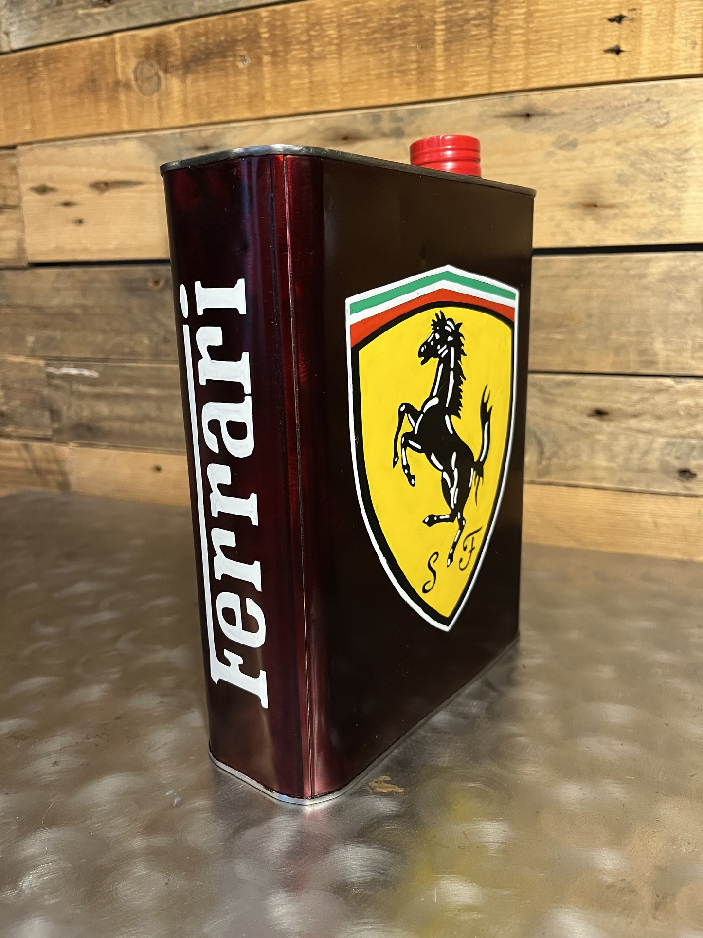 Ferrari red hand-painted custom vintage automotive vintage automotive oil can, created by Mathieu Ollevier from Vintage Addict, limited edition of 10, 23x17 cm format. Right view showcasing the handpainted detail, a collector’s piece for automotive, vintage and art enthusiasts.