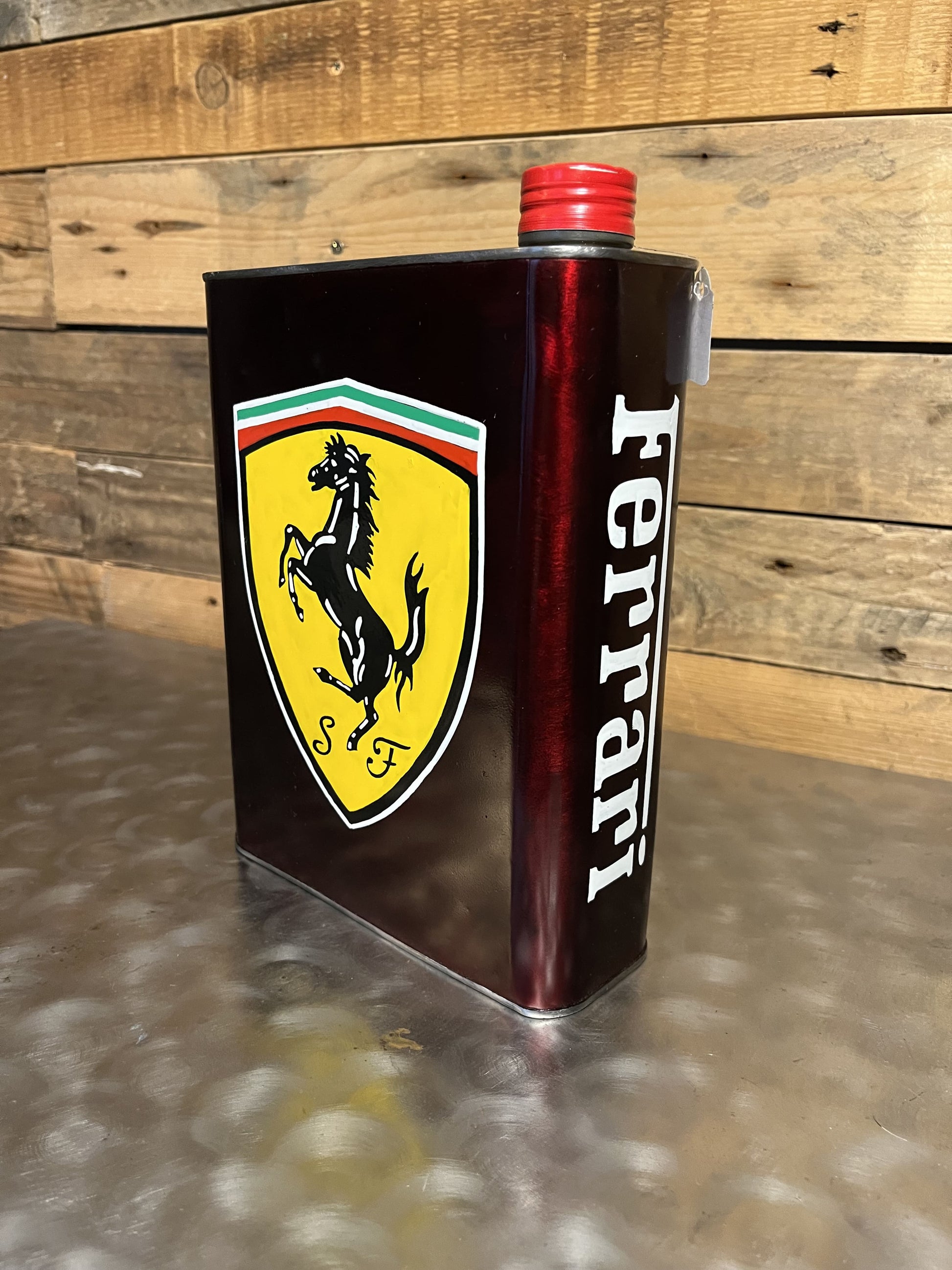 Ferrari red hand-painted custom vintage automotive vintage automotive oil can, created by Mathieu Ollevier from Vintage Addict, limited edition of 10, 23x17 cm format. Left view showcasing the handpainted detail, a collector’s piece for automotive, vintage and art enthusiasts.