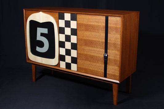 Solid wood furniture representing a Ford A Speedster Bar, created by Stéphane Carton from Atelier Stéphane Carton, woodworker & cabinetmaker.

Limited edition of 25, 140 x 45 x 106 cm, solid oak, marquetry in maple and swamp oak. Personalization possible.

Perfect for vintage automotive design lovers, classic cars enthusiasts and Ford owners. Front view.