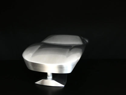 Metal sheet automotive sculpture with raw aluminium representing a Ford GT40 evocation, created by Frédéric Girard, limited edition of 8, 45x19 cm format. Front view showcasing the iconic curves and the meticulous attention to each sculpted detail, a collector’s piece for automotive and fine craftsmanship enthusiasts.