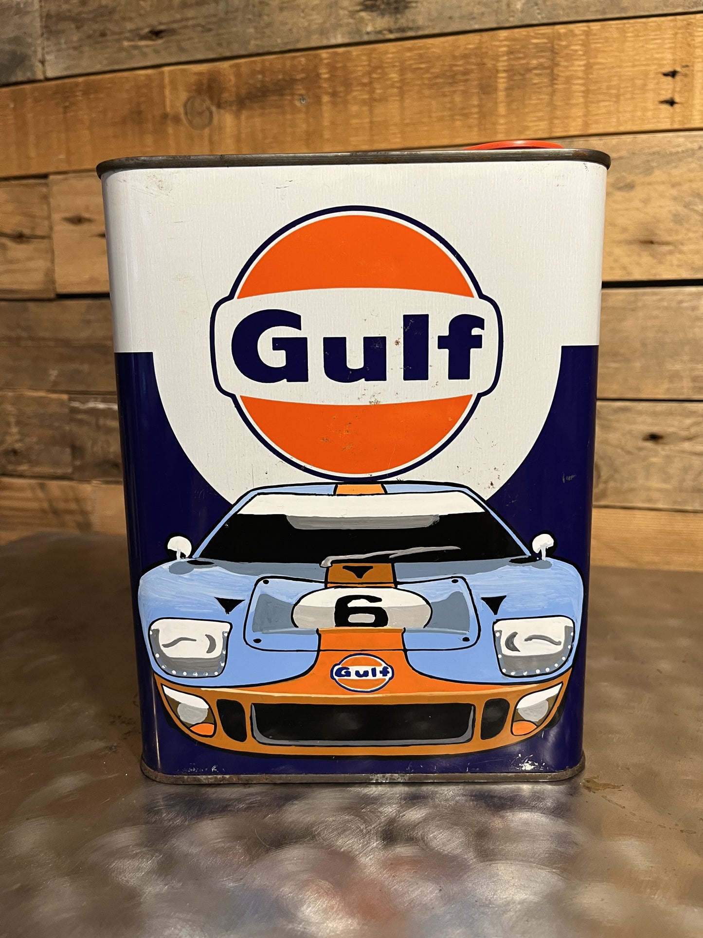 Ford GT 40 Gulf hand-painted custom vintage automotive vintage automotive oil can, created by Mathieu Ollevier from Vintage Addict, limited edition of 10, 23x17 cm format. Front view showcasing the handpainted detail, a collector’s piece for automotive, vintage and art enthusiasts.