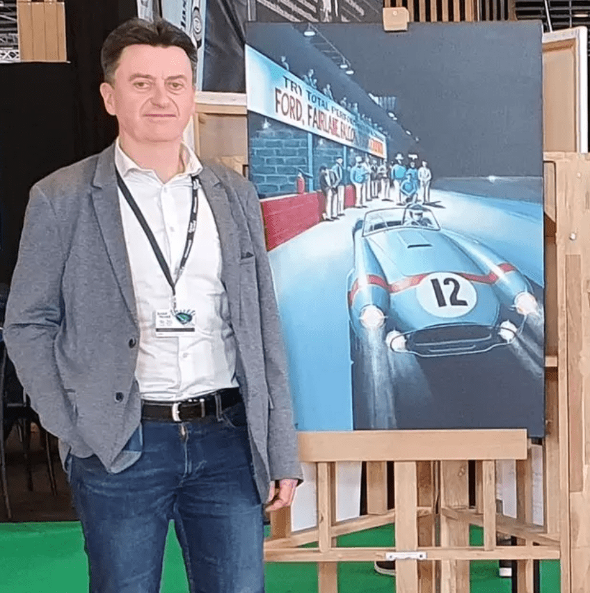 Jean-Marie Corre in front of one of his paintings during Retromobile