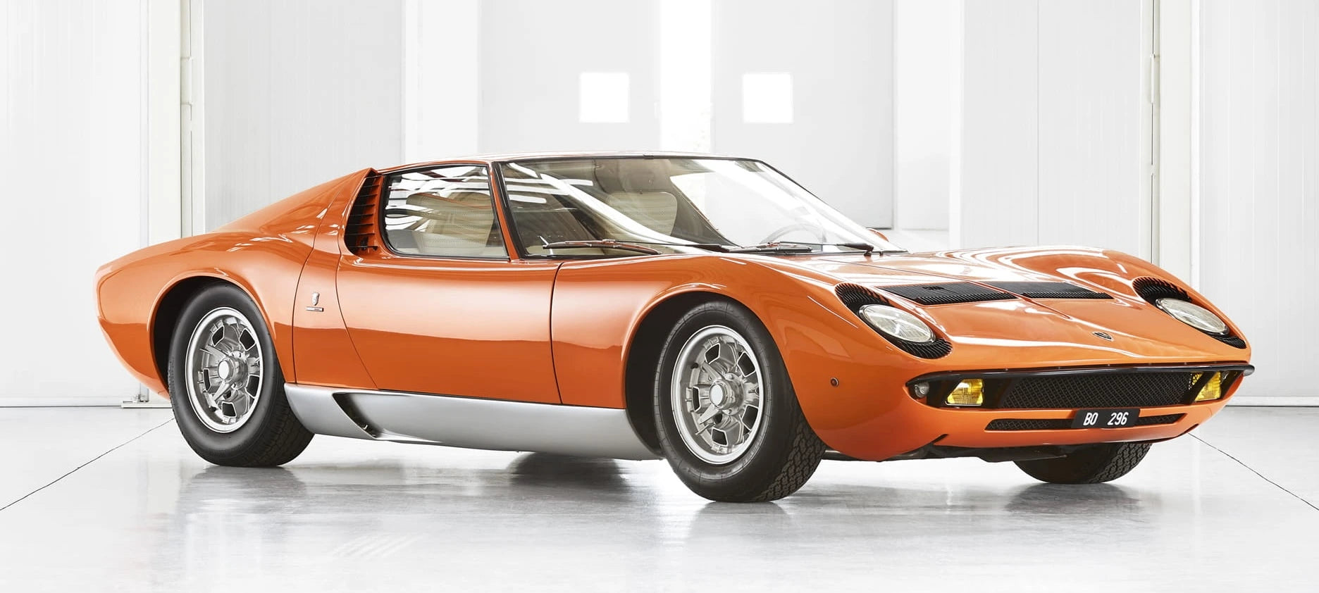 Lamborghini Miura P 400 SV in orange in a luxury garage