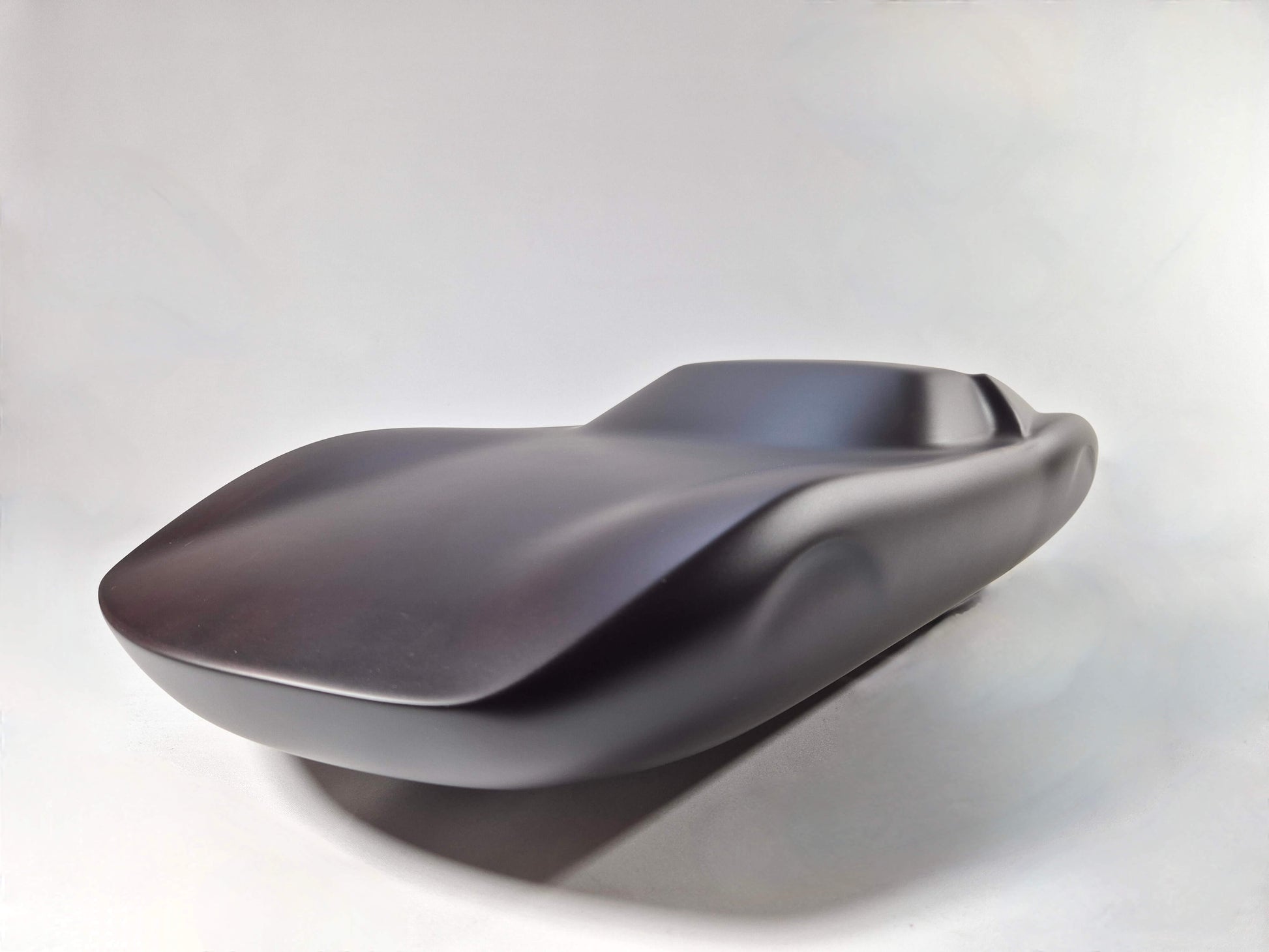 Solid mahogany sculpture with ebony matte finish representing a Lamborghini Miura, created by David Voisin from Maison V&P, limited edition, 30x66 cm. Front left view capturing the iconic front end and dynamic curves of this legendary supercar, a collector’s piece for automotive and fine craftsmanship enthusiasts.