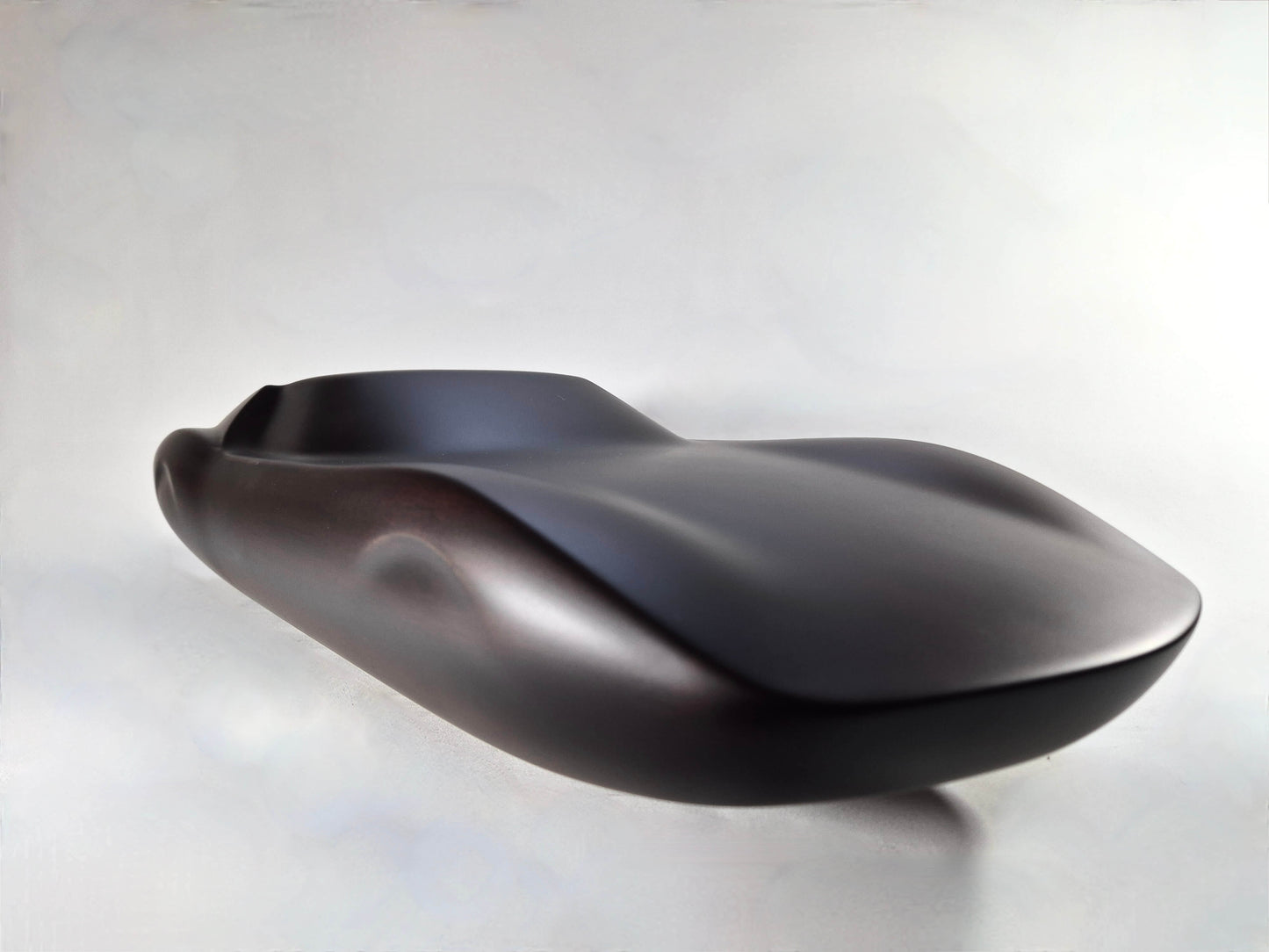 Solid mahogany sculpture with ebony matte finish representing a Lamborghini Miura, created by David Voisin from Maison V&P, limited edition, 30x66 cm. Front right view unveiling the iconic lines and elegant silhouette of this collectible supercar, a work of art for automotive and fine craftsmanship enthusiasts.
