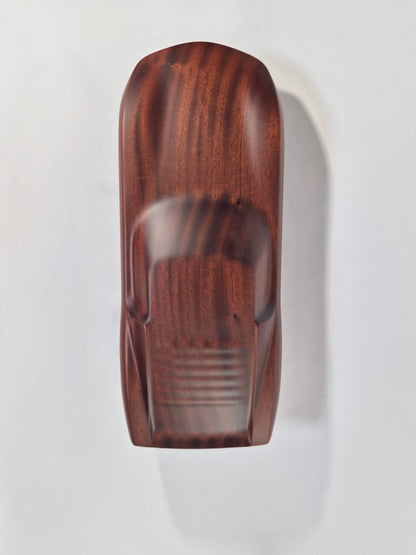 Solid mahogany sculpture with natural matte finish representing a Lamborghini Miura, created by David Voisin from Maison V&P, limited edition, 30x66 cm format. Top view revealing the elegance of the lines and the fluidity of the silhouette of this legendary supercar, a collector’s piece for automotive and fine craftsmanship enthusiasts.