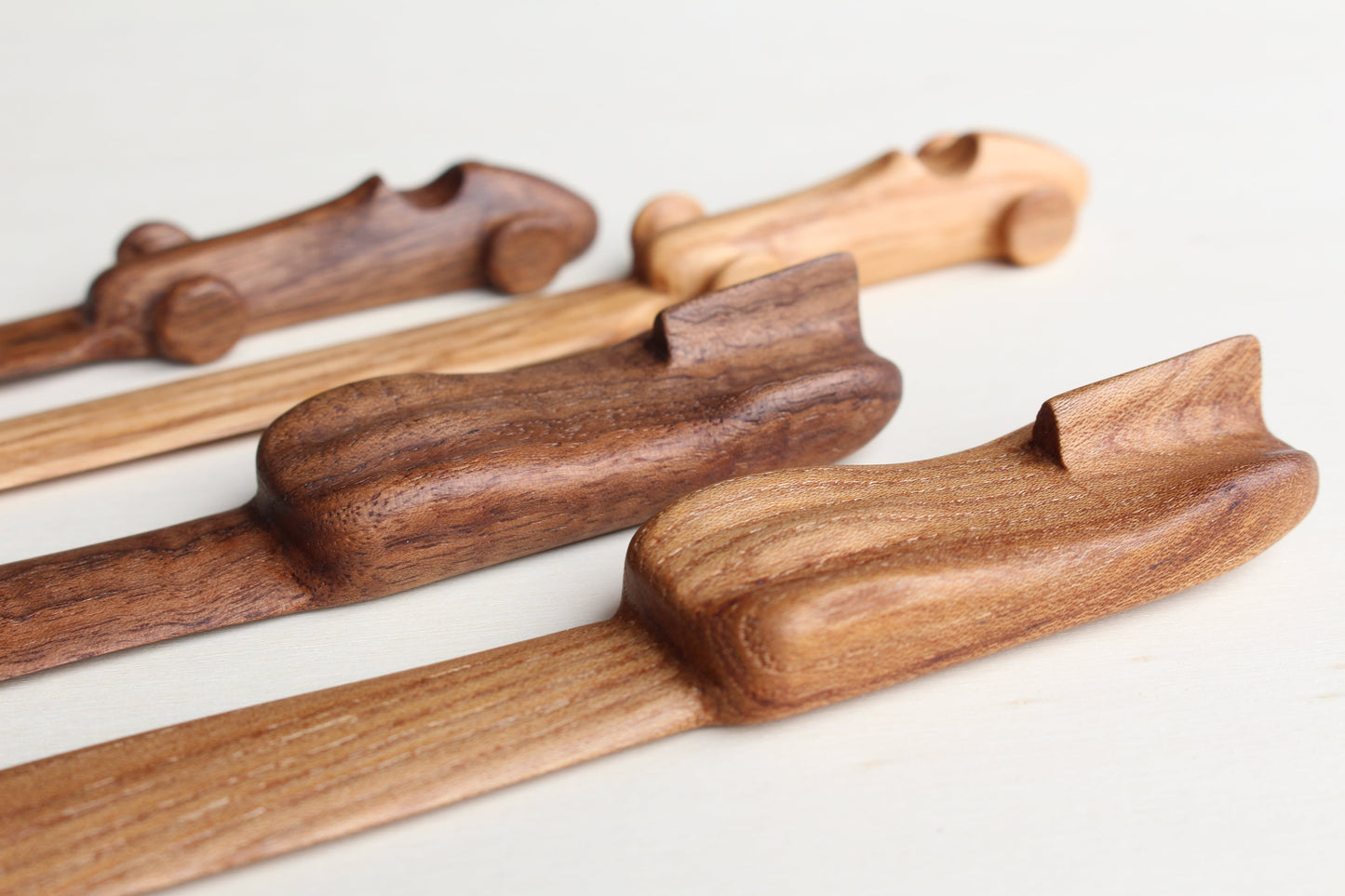 Solid wood desk decoration representing a Maserati 4CLT, a Jaguar D-Type and a Porsche 356 letter opener, created by Stéphane Carton from Atelier Stéphane Carton, woodworker & cabinetmaker.

Olive ash or American oak, black, red or cognac leather case. Personalization possible.

Perfect for vintage automotive tool desk lovers, classic cars enthusiasts and Maserati, Porsche & Jaguar owners. 3/4 view .