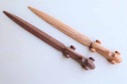 Solid wood desk decoration representing a Maserati 4CLT letter opener, created by Stéphane Carton from Atelier Stéphane Carton, woodworker & cabinetmaker.

American oak or Olive ash, black, red or cognac leather case. Personalization possible.

Perfect for vintage automotive tool desk lovers, classic cars enthusiasts and Maserati owners. Top view with 2 exemplaries.