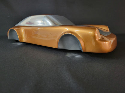 Metal sheet automotive sculpture with silver and gold finish representing a Porsche 911 Flat 6, created by Frédéric Girard, limited edition of 8, 58x25 cm format. Side view showcasing the iconic curves and the meticulous attention to each sculpted detail, a collector’s piece for automotive and fine craftsmanship enthusiasts.